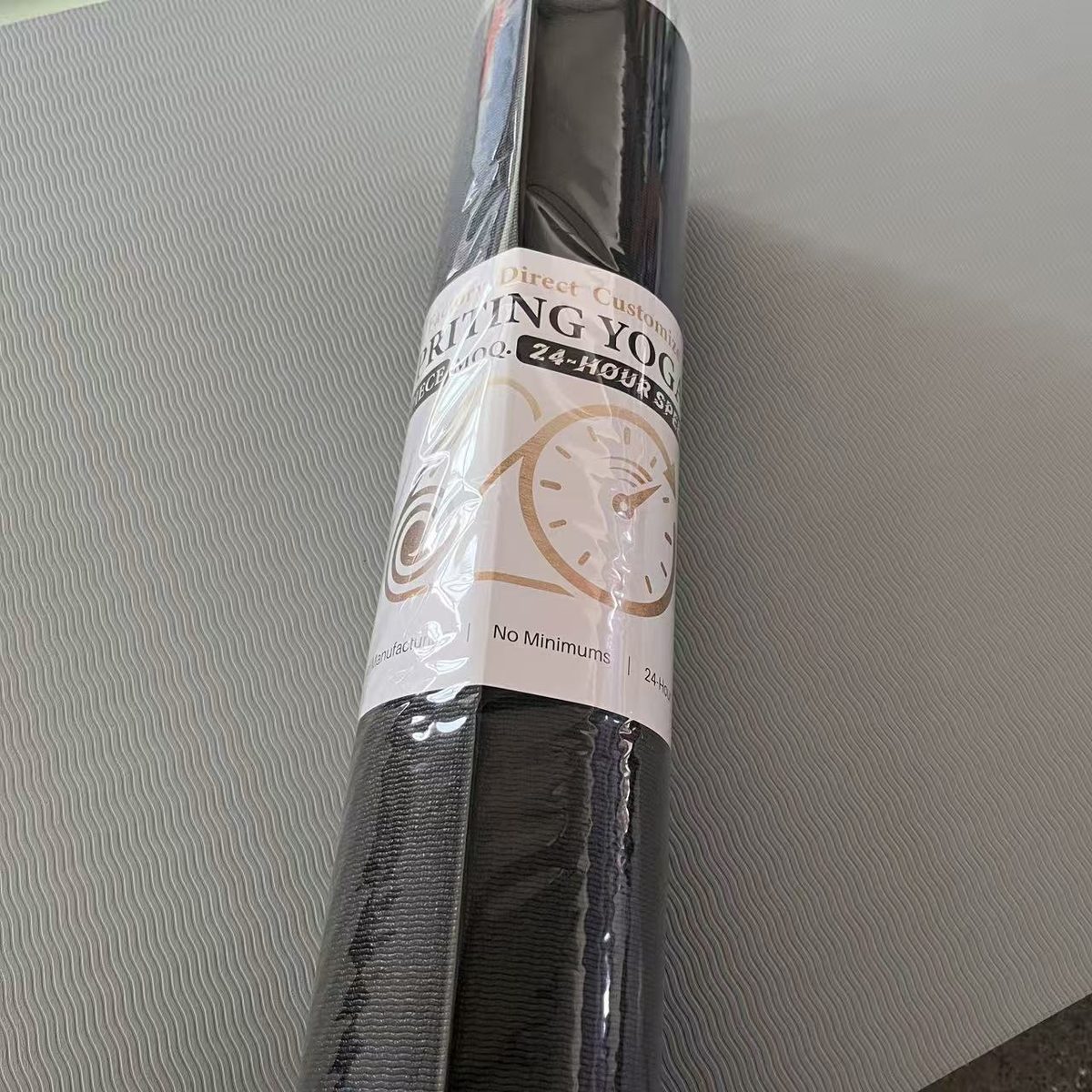 Custom branded retail sleeve on a rolled yoga mat