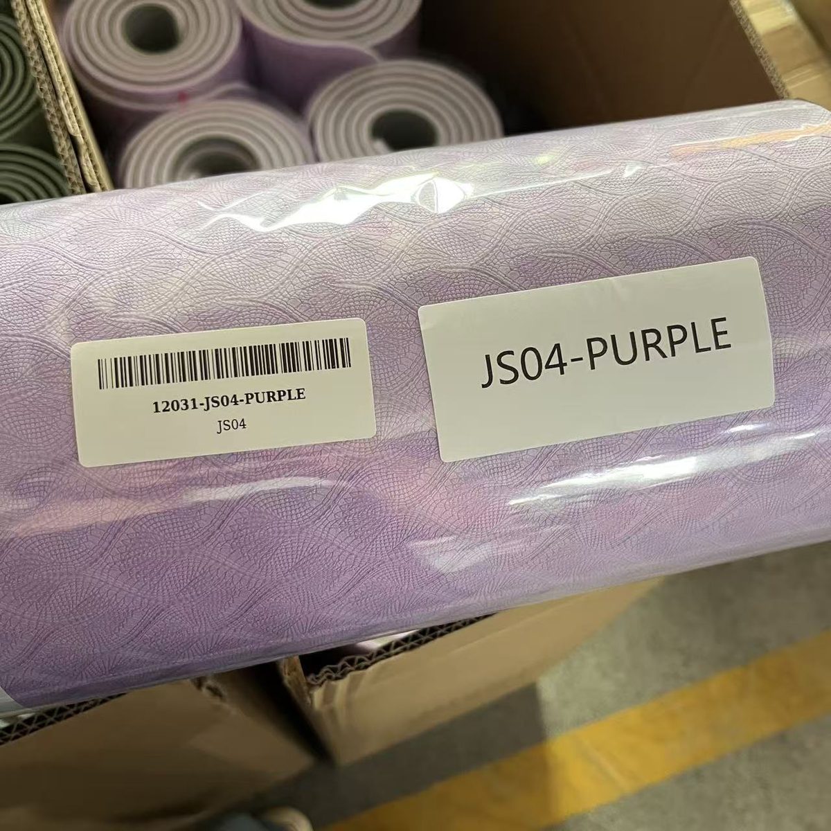 Yoga mat rolls sleeved and labelled with SKU barcodes